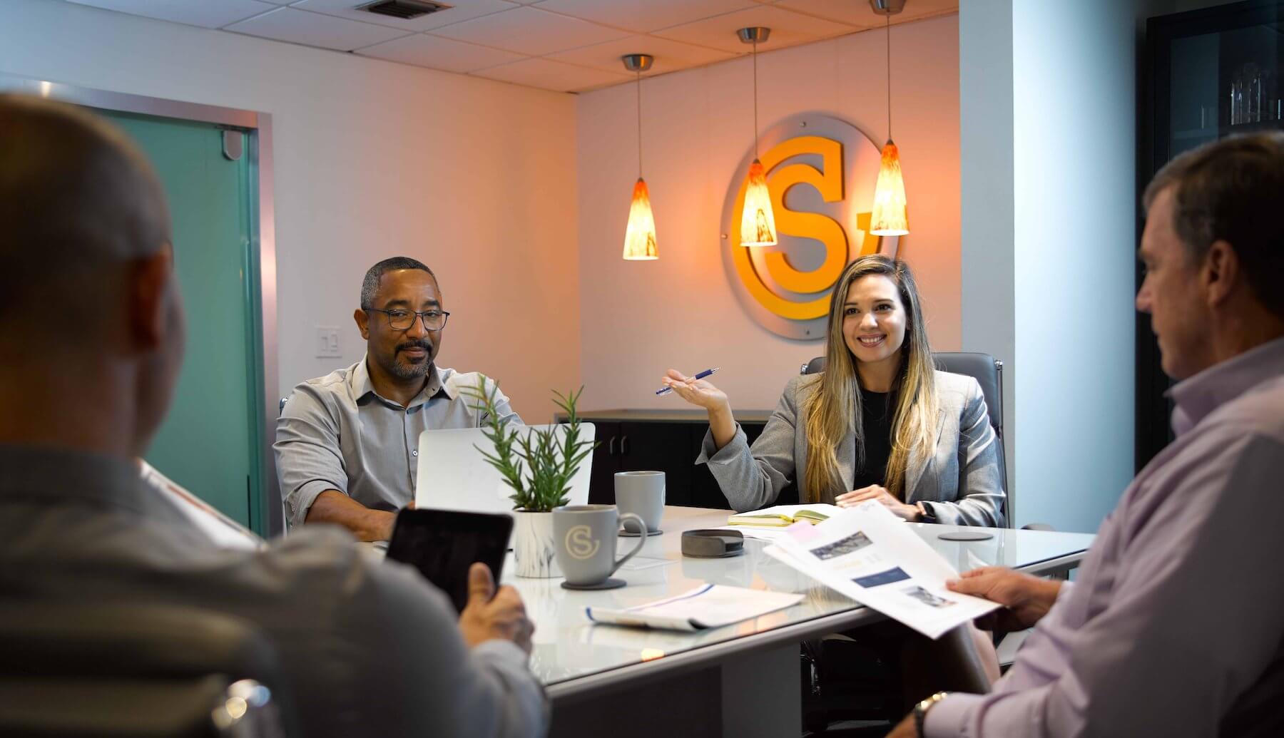 Southeastern employees talking around a conference room table